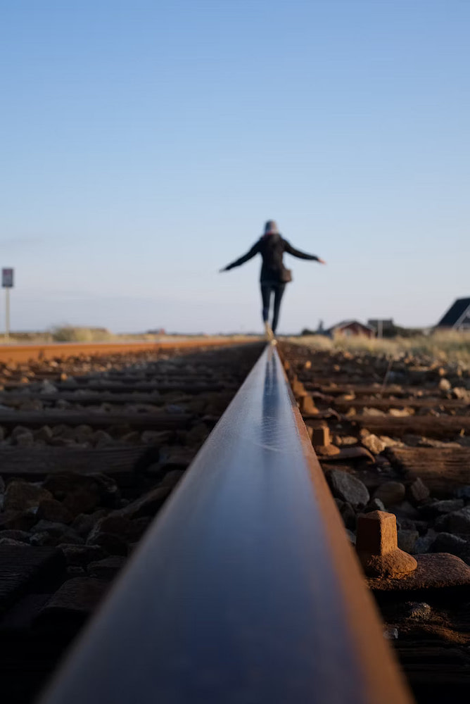 Woman Balancing and Walking on a Railroad Rail |BioFit St Louis
